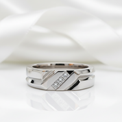 Silver ring with a diamond on a white background
