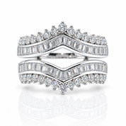 A double ring set in bright white metal, featuring rows of baguette and round brilliant-cut diamonds. The top ring has a crown-like diamond pattern, and the bottom ring mirrors it with a pointed diamond center, set against a clean white background with a soft reflection.