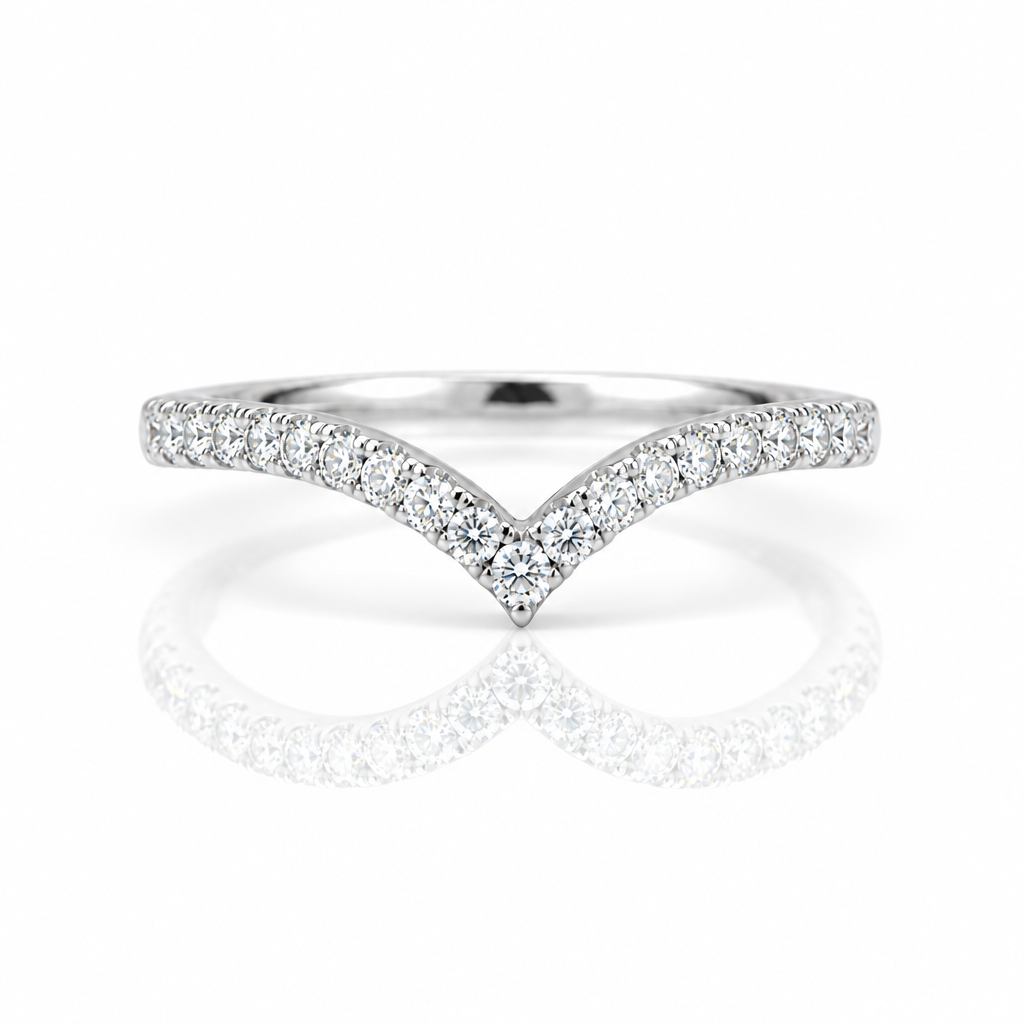 A silver V-shaped diamond ring with pavé-set round diamonds on a clean white background with a soft reflection below.
