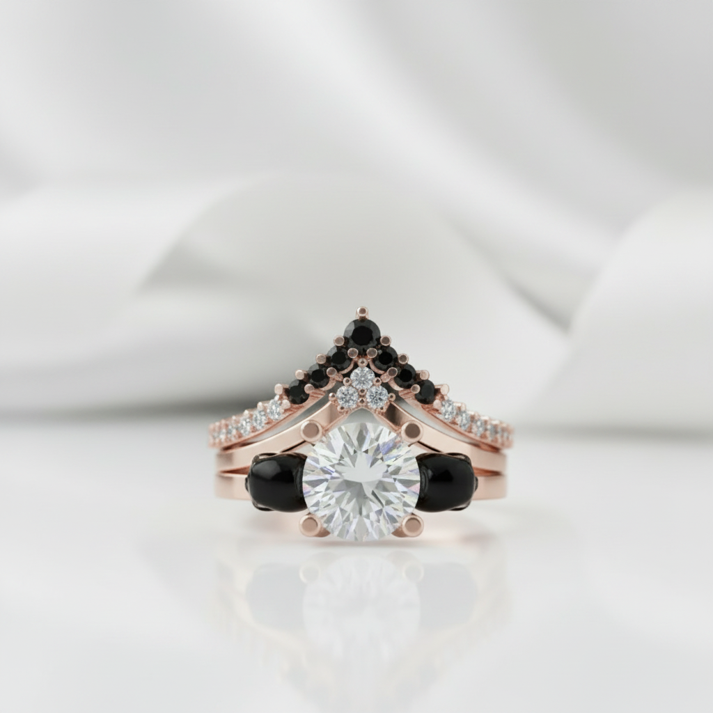 Rose gold ring with black gemstones and clear central stone on a white background