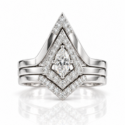 A silver-toned diamond ring set featuring a marquise-cut center stone surrounded by double halo settings, with additional marquise and round diamonds on the band, shown on a white background with a soft reflection.
