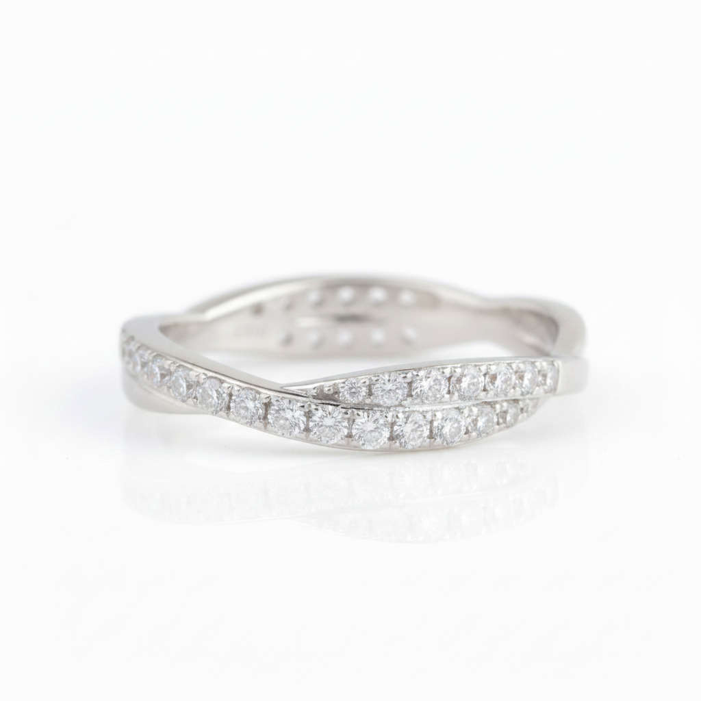 A silver-tone wavy band ring paved with round clear gemstones, shown on a clean white background with a soft reflection.