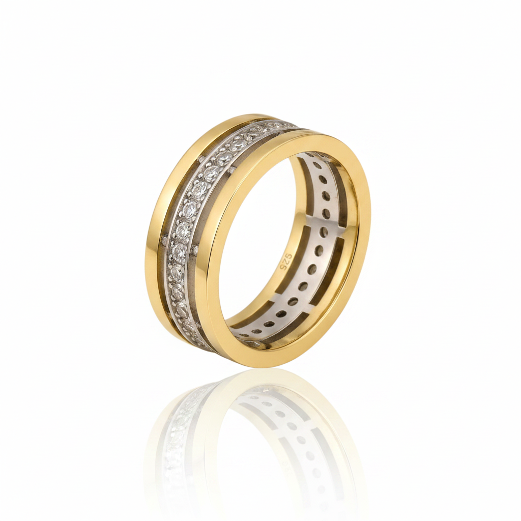 A two-tone yellow gold ring with a channel-set diamond band, displayed on a clean white background with a soft reflection below.