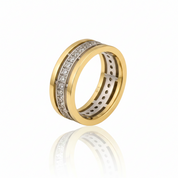 A two-tone yellow gold ring with a channel-set diamond band, displayed on a clean white background with a soft reflection below.