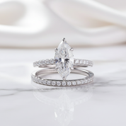 Two diamond rings on a soft white background