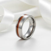 Silver ring with wooden inlay on a white background