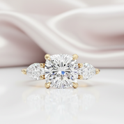 Diamond ring with gold accents on a soft pink fabric background