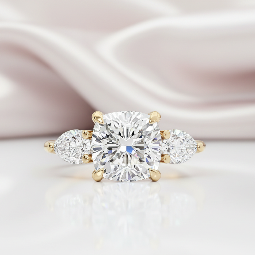 Diamond ring with gold accents on a soft pink fabric background