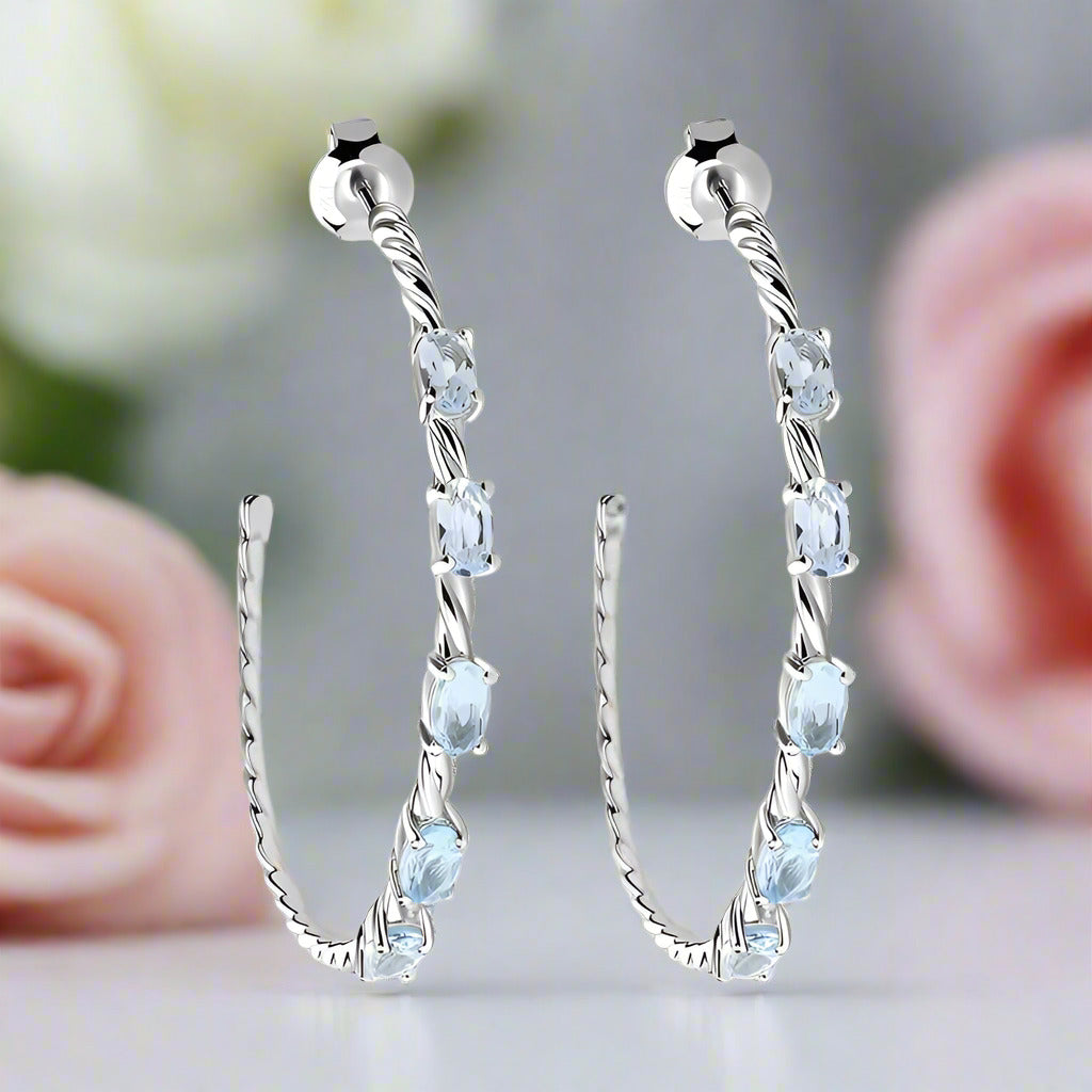 2.94 Ctw Oval Sky Blue Topaz Hoop Earrings-Black Diamonds New York